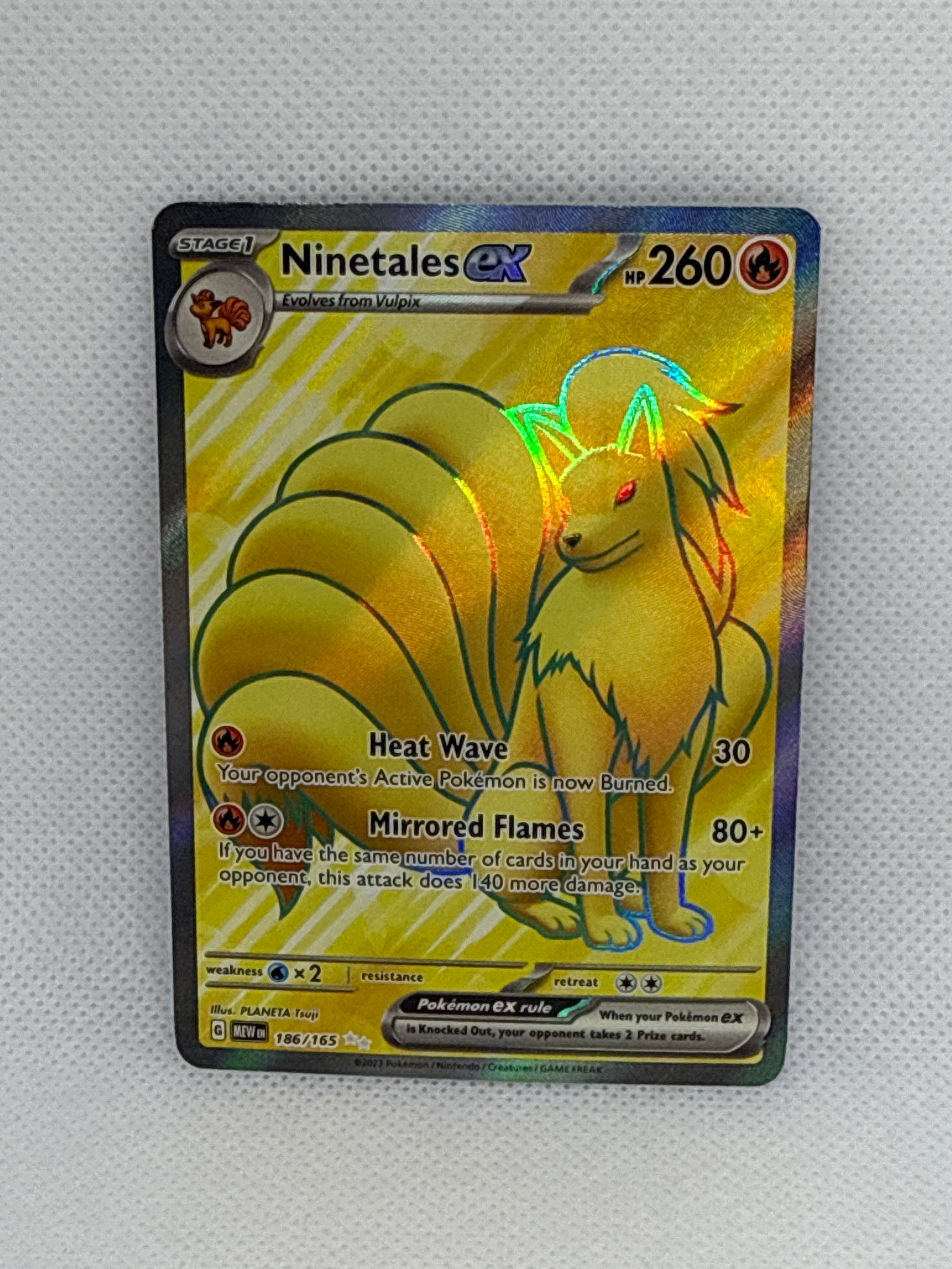 Pokémon trading card featuring Ninetales GX on a textured gray background